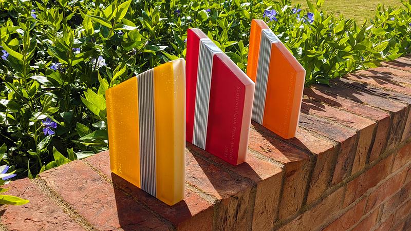 Three Scottish Book Trust Awards on brick wall outside